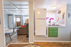 a kitchen with a refrigerator and a living room at Rustic 2 Bedroom Boho Apartment in Laramie