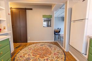 a kitchen with a door and a rug on the floor at Rustic 2 Bedroom Boho Apartment in Laramie +16 photos