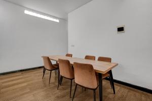 a conference room with a wooden table and chairs at Collection O Yayah Residence in Bogor