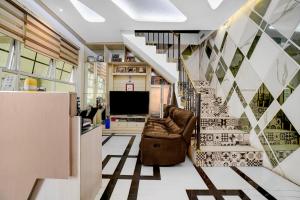 a living room with a staircase and a couch at Collection O Yayah Residence in Bogor