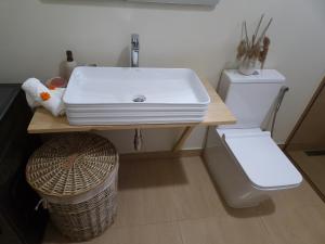 a bathroom with a sink and a toilet at Ka Nicita - Beach house with pool in Praia de Macaneta +47 photos