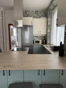 a kitchen with a wooden counter top in a room at El Arca de Noé in Luarca