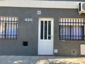 a white door on the side of a building at Kallpa in Santa Rosa