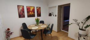 a dining room with a table and chairs at Pakeliui I -On the way I in Baltrušaičiai