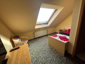 a small attic room with a bed and a window at Pension Serbitzer Hof in Serbitz +4 photos