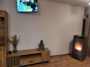 a living room with a tv on a white wall at Agrobiskupin Kaczmarek in Gąsawa