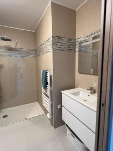 a bathroom with a shower and a sink and a tub at Loc A Machja Fiurita 3 appartements - Pietrosella et Ajaccio in Pietrosella +62 photos
