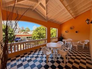 a room with a table and chairs on a balcony at Hotel Siena Pinamar in Pinamar