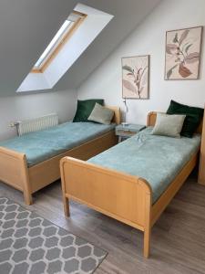 two beds sitting next to each other in a room at Pension Lizzi in Vienna