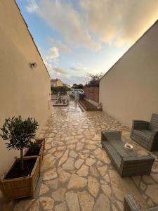 an outdoor patio with a couch and a table at Villa Casa Luma in Balaruc-les-Bains