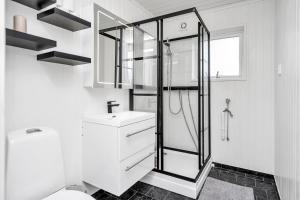 a white bathroom with a sink and a shower at Oddernesveien 7 in Kristiansand +34 photos