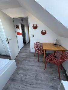 a room with a wooden table and two chairs at Pension Lizzi in Vienna