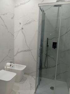a white bathroom with a shower and a toilet at Villa Anna al Duomo in Taormina