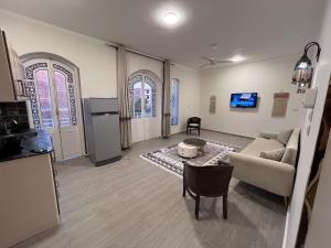 a living room with a couch and a table at Nile view retreat I in Luxor