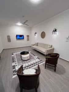a living room with a couch and a table at Nile view retreat I in Luxor