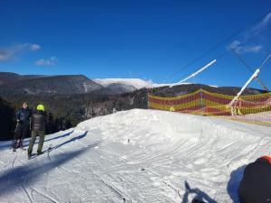 a couple of people standing on a ski slope at Privát Stelly in Dolná Lehota