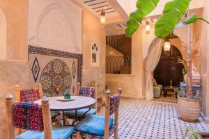 a patio with a table and chairs in a room at Riad Horizon in Essaouira +60 photos
