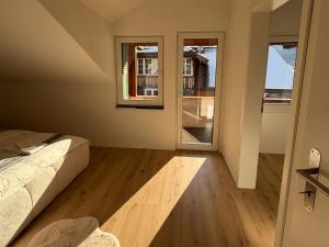 a bedroom with a bed and a large window at Deine Auszeit mit Alpen- und Kanderblick in Kandergrund