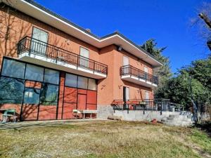 a large brick building with balconies on top of it at La Mandulera in Rivalta di Torino