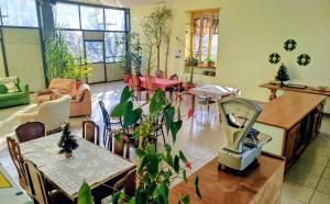 a living room with tables and chairs and a living room at La Mandulera in Rivalta di Torino