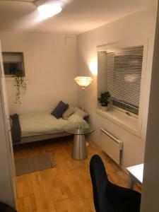 a small room with a bed and a table and a window at Trondhjemsvegen in Gjøvik