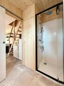 a bathroom with a shower with a glass door at Le KuboLodge - Tiny House premium in Jacou +25 photos