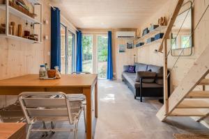 a tiny house with a staircase and a living room at Le KuboLodge - Tiny House premium in Jacou
