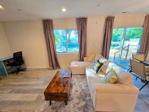 a living room with a white couch and a table at Lakefront Retreat • Private Yard + Fireplace in Clearlake Oaks