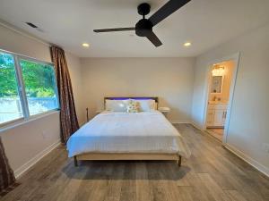 a bedroom with a bed and a ceiling fan at Lakefront Retreat • Private Yard + Fireplace in Clearlake Oaks