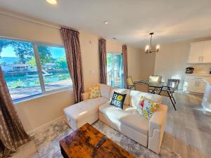 a living room with a couch and a table at Lakefront Retreat • Private Yard + Fireplace in Clearlake Oaks
