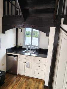 a kitchen with a sink and a window at Six Pillars Resort in Bastimentos