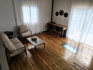 a living room with a couch and a table and a piano at Six Pillars Resort in Bastimentos