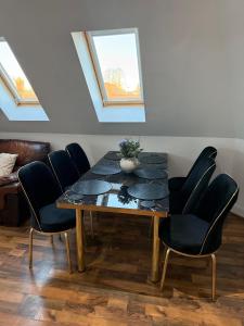 a dining room with a table and chairs at Guildford Court Apartment Colchester in Colchester +5 photos