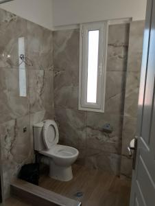 a bathroom with a toilet and a window at Villa Ioulia Malakonda, Eretria ,Greece in Eretria +21 photos