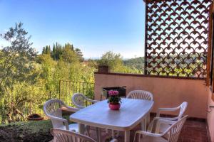 a white table and chairs on a patio at Casa l'Oca in Figline Valdarno