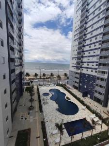 an aerial view of a resort with a swimming pool and the ocean at Refúgio Brisa e Mar in Mongaguá
