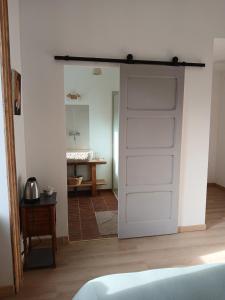 a white door in a room with a bathroom at Gradine et Boucharde in Le Monastier sur Gazeille