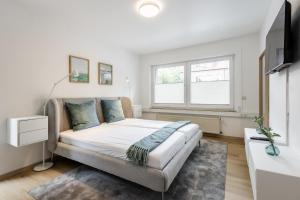a bedroom with a large bed and a window at Ems Suite 1 in Warendorf