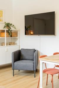 a living room with a chair and a table at Ems Suite 1 in Warendorf
