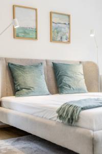 a bed in a room with two pictures on the wall at Ems Suite 1 in Warendorf +13 photos
