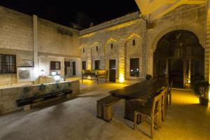 a large room with a table and chairs in a building at Birsen Hanım Konağı in Mardin