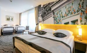 Postel nebo postele na pokoji v ubytování Hotel Grad