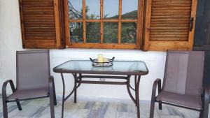 a table with two chairs and a candle on it at Villaggio View in Kariá