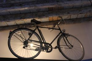 a bike hanging from the ceiling of a building at Le Dimore di San Nicola in Favara