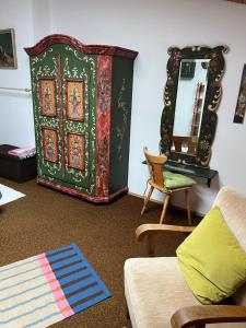 a living room with a dresser and a mirror at Ferienwohnung Ewa in Grassau +26 photos