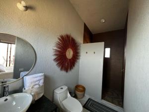 a bathroom with a sink toilet and a mirror at Casa de los Agaves in Bernal +17 photos