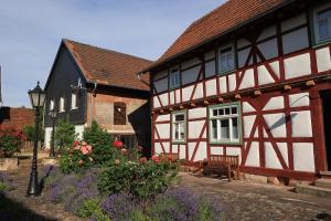 a group of buildings with flowers and a street light at Ferienhaus Kieselbach in der thüringischen Rhön in Kieselbach