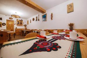 a table with a table cloth with a flower on it at Willa Wincentówka w sercu Uzdrowiska in Szczawnica