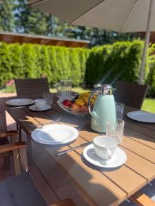 a table with a teapot and plates on it at Ferienhaus Happyplace in Illach