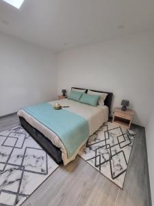 a bedroom with a bed and a rug at Portela ALR in Portela da Memória +33 photos